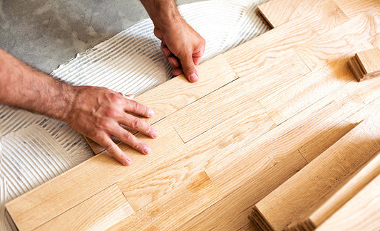 A person installing flooring